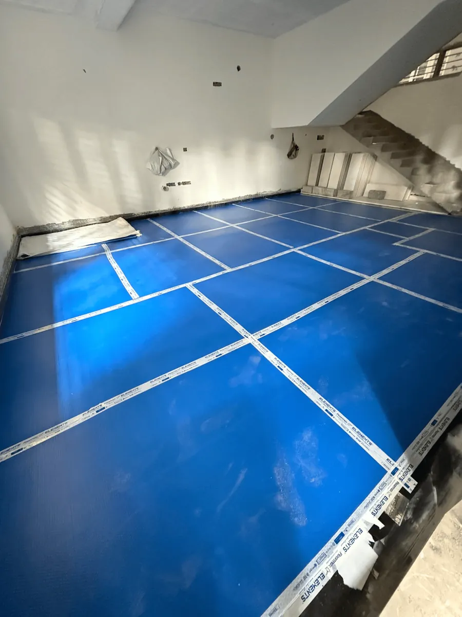 Protection sheet covering marble flooring at a construction site